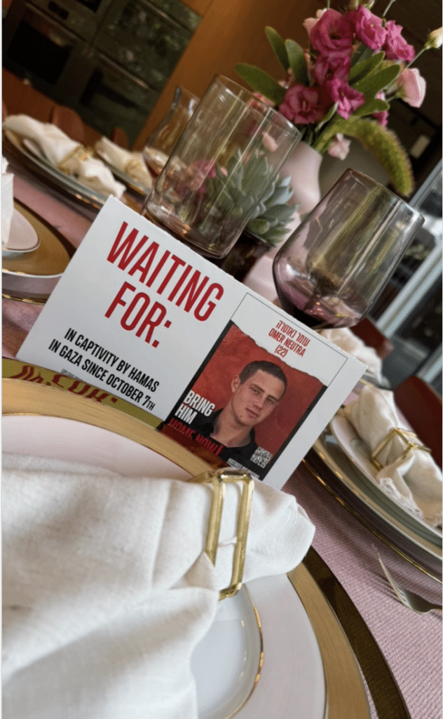 Placard calling for Omer's release at a Shabbat dinner.